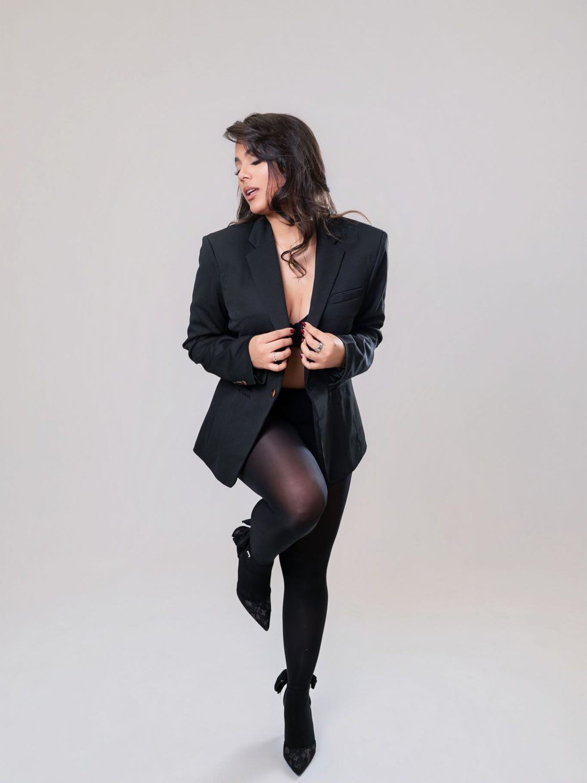 Editorial branding pose in a black blazer