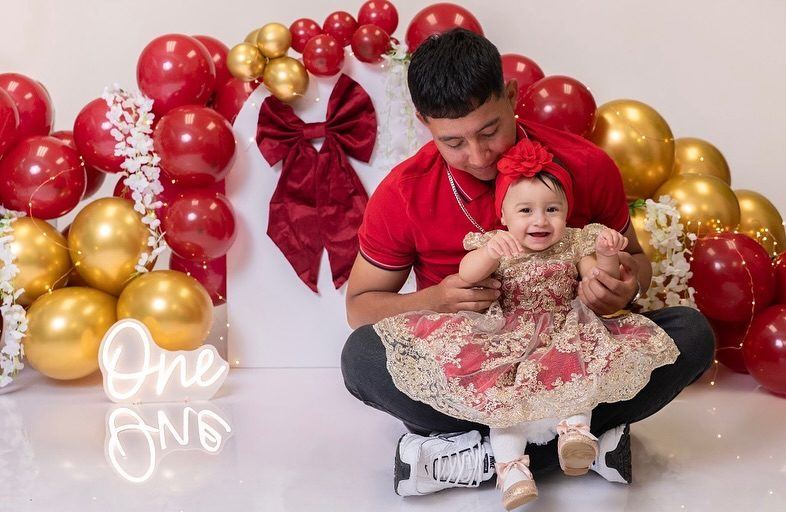 First-birthday session with dad, gold and red balloons