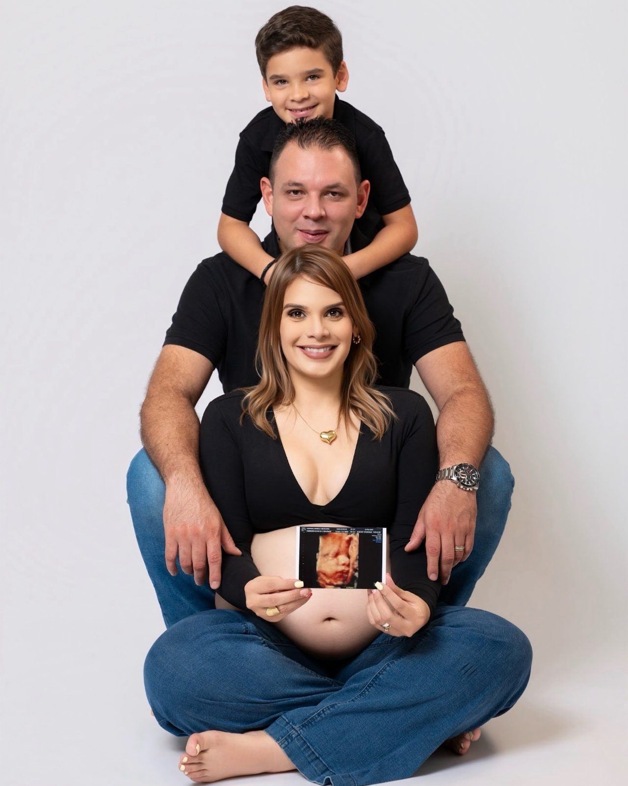 Family maternity portrait with dad, son, and an ultrasound
