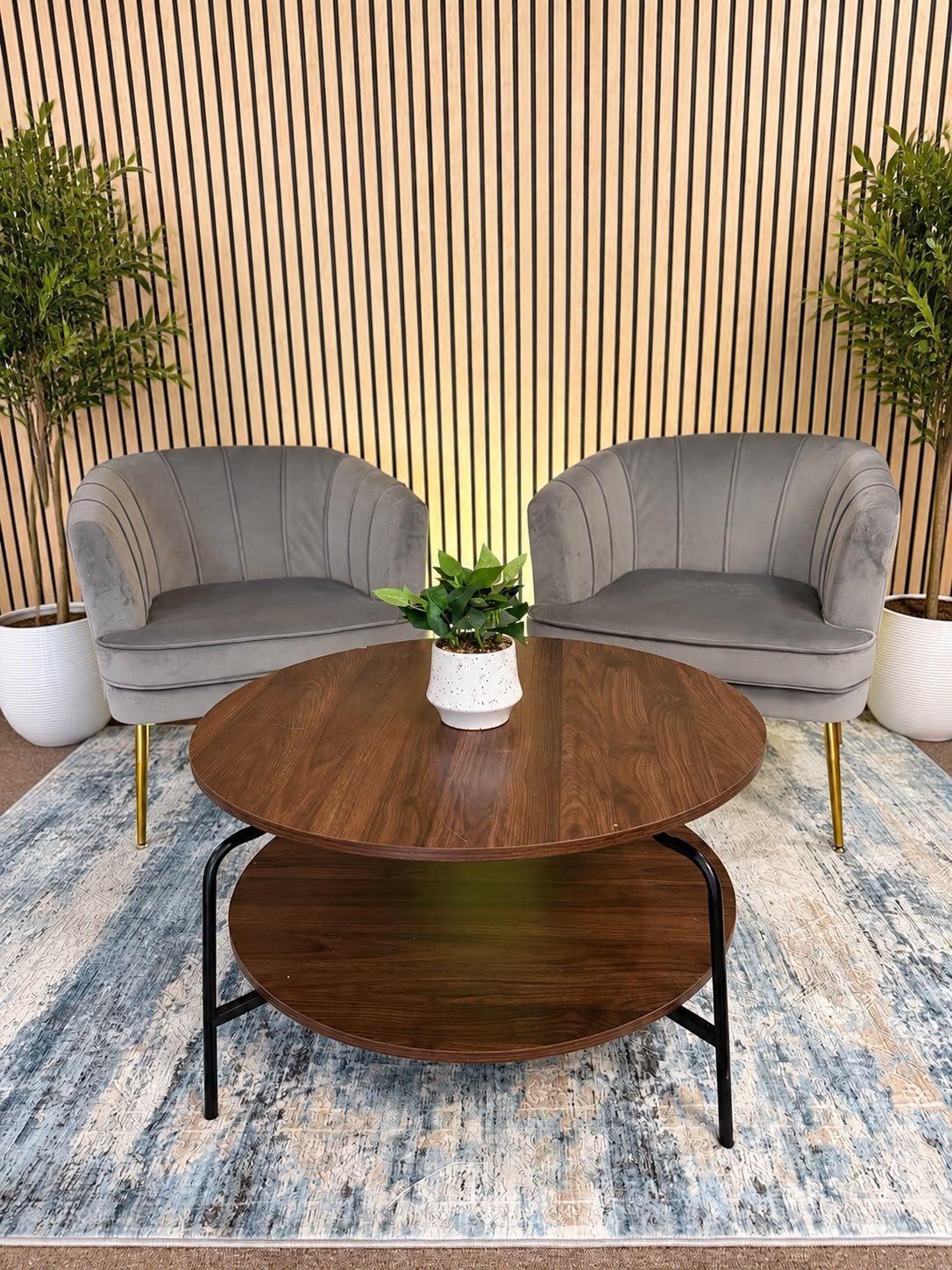 Podcast interview set with velvet chairs and a wood-slat wall