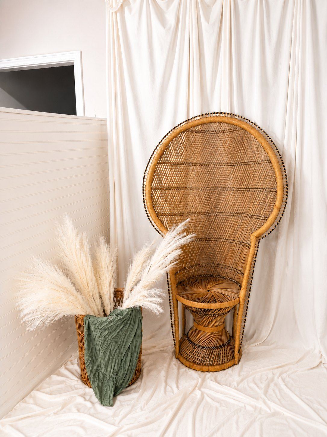Peacock chair, pampas, and draped linen for portrait sets